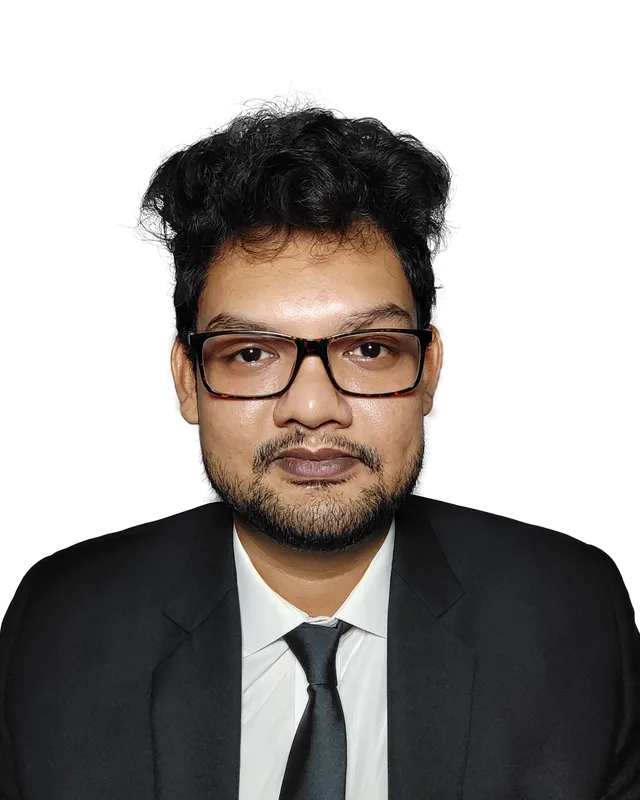 Sagnik Bhattacharya, founder of Coding Liquids, in a dark suit and glasses.