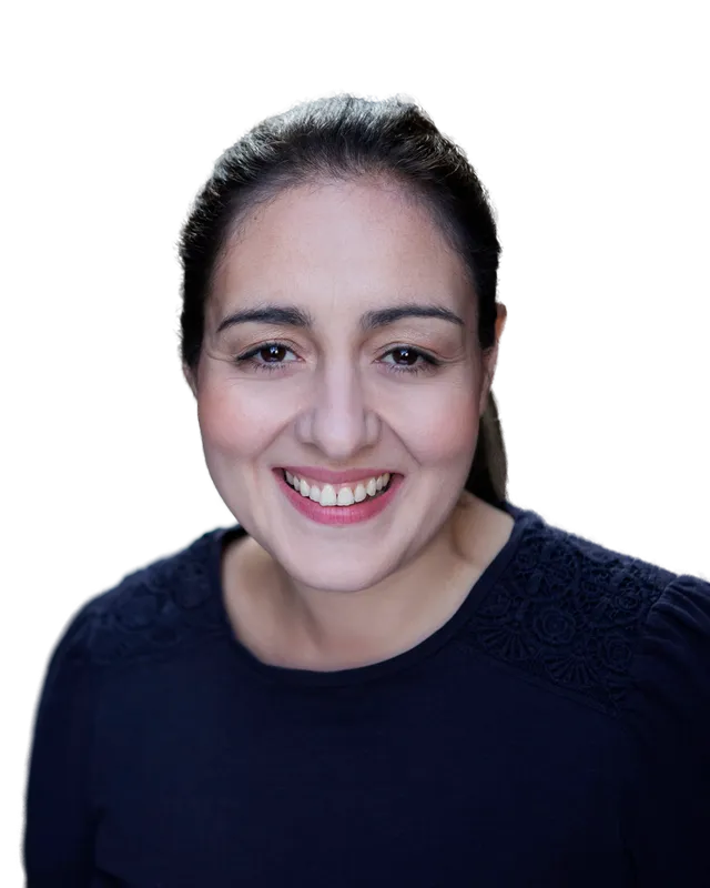 Virginia Thorn smiling at the camera, dark hair tied back, wearing a navy top.