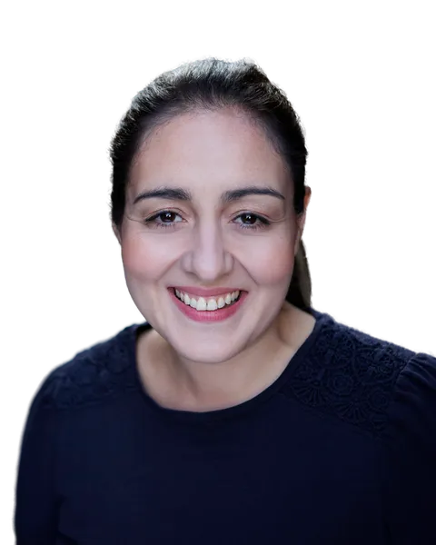 Virginia Thorn smiling at the camera, dark hair tied back, wearing a navy top.